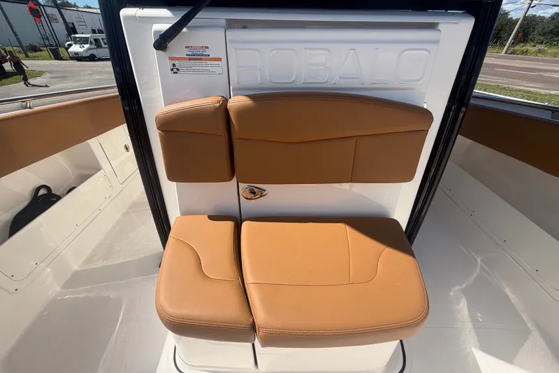 Slide: The Image of 2025 Robalo R302 Center Console boat with tan cushioned seating. - 60