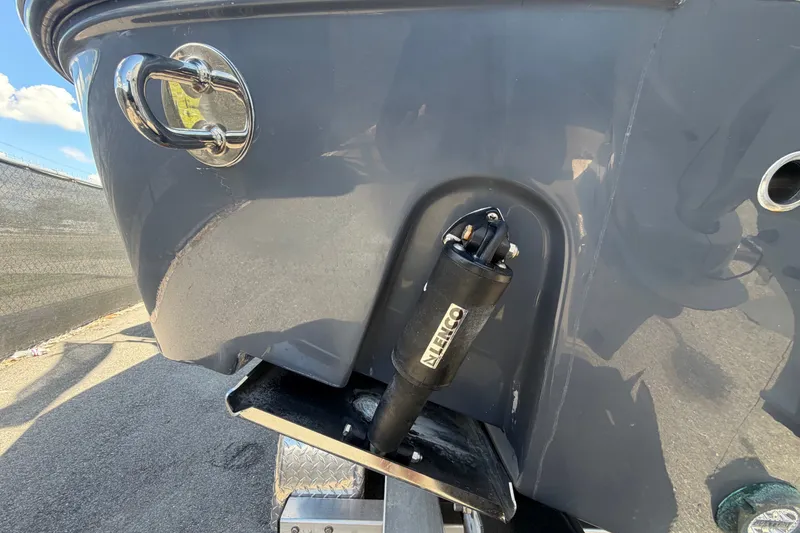 Slide: The Image of 2025 Robalo R302 Center Console boat with Lenco trim tab detail. - 9
