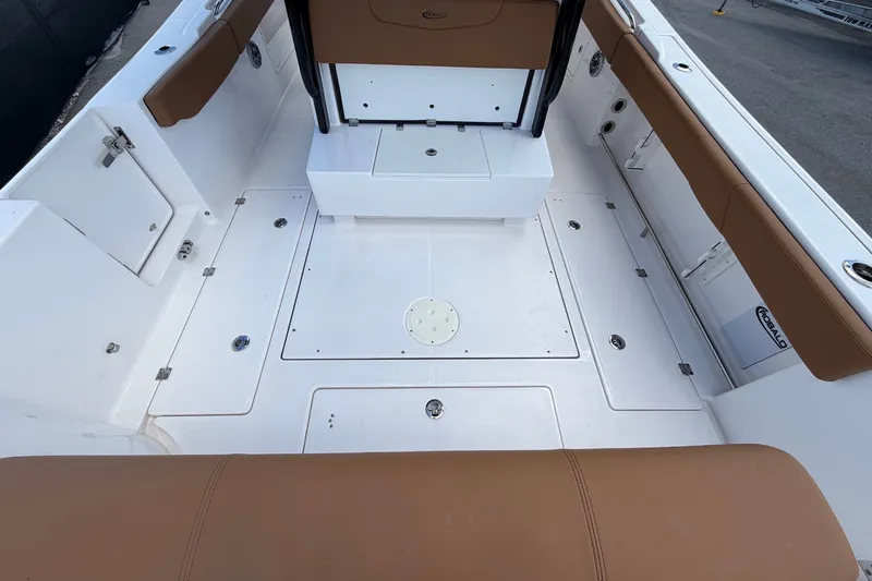 Slide: The Image of The image shows the cockpit of a 2025 Robalo R302 Center Console boat with brown upholstery. - 17