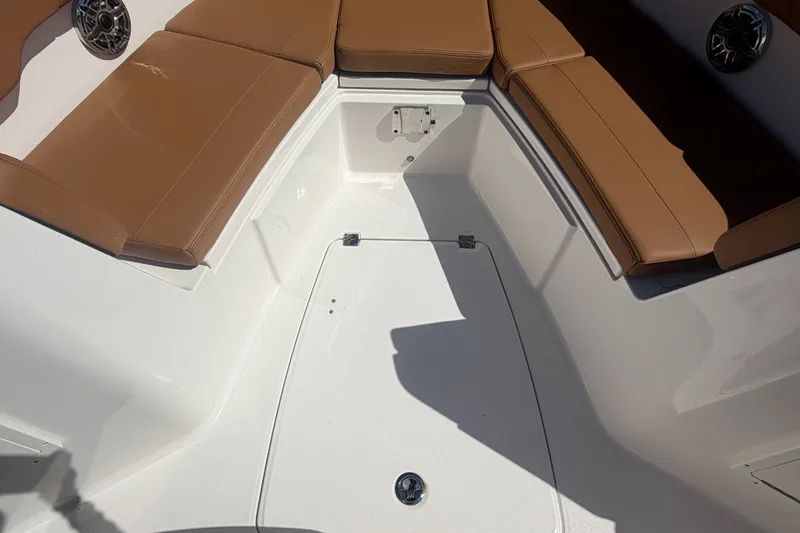 Slide: The Image of 2025 Robalo R302 Center Console boat interior with tan seating and white deck. - 51