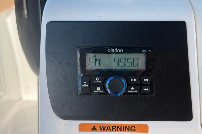 Slide: The Image of Clarion CMR-20 radio display on 2025 Robalo R302 Center Console boat dashboard. - 33