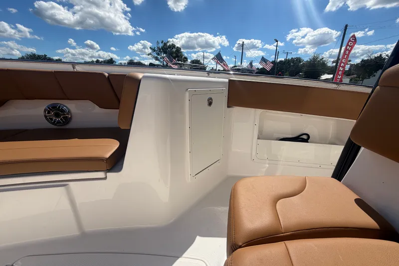 Slide: The Image of 2025 Robalo R302 Center Console interior with tan seating and storage compartments. - 66