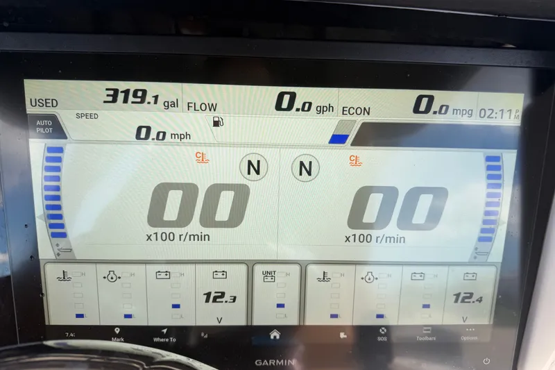 Slide: The Image of Garmin display on 2025 Robalo R302 Center Console showing fuel usage and engine metrics. - 30