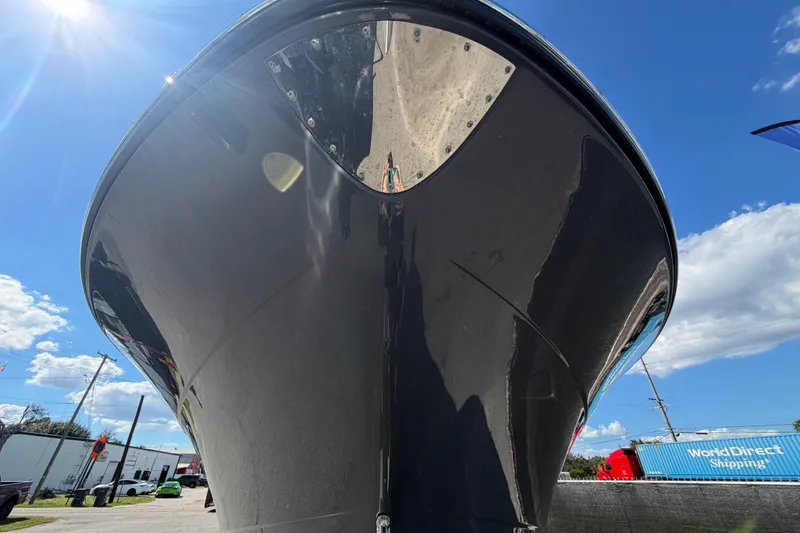 Slide: The Image of 2025 Robalo R302 Center Console boat under bright blue sky. - 13