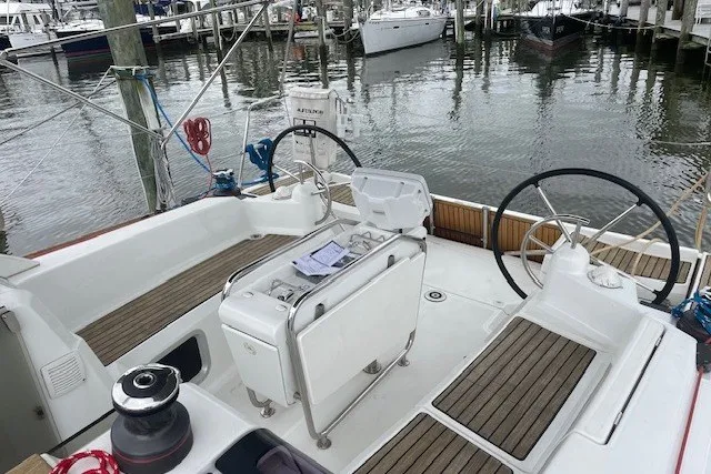 Slide: The Image of 2017 Jeanneau Sun Odyssey 389 sailboat cockpit with dual steering wheels at marina. - 22