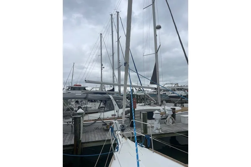 Slide: The Image of 2017 Jeanneau Sun Odyssey 389 sailboat docked at marina under cloudy skies. - 20