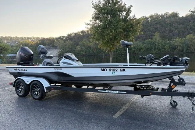 Slide: The Image of 2022 Vexus AVX2080 boat on trailer, parked near a scenic lake with trees. - 57