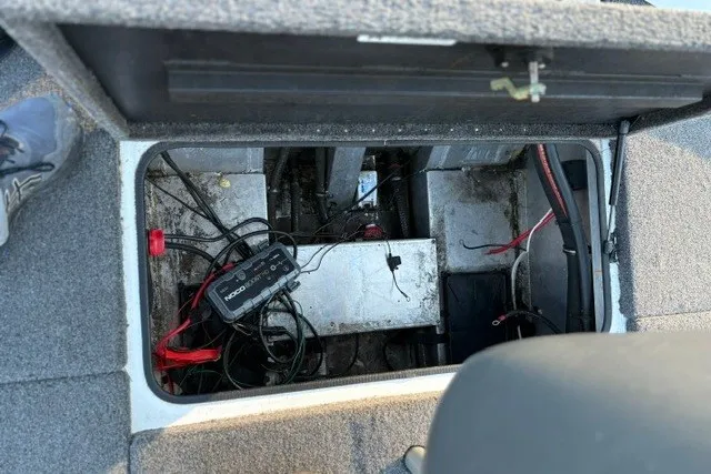Slide: The Image of Open compartment of a 2022 Vexus AVX2080 boat showing wiring and battery setup. - 37