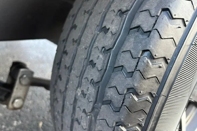 Slide: The Image of Close-up of a 2022 Vexus AVX2080 tire with detailed tread pattern. - 65