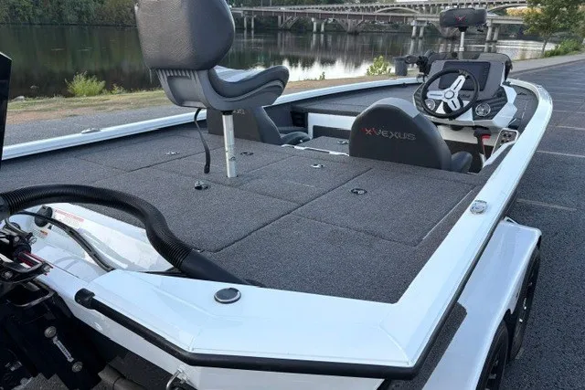 Slide: The Image of 2022 Vexus AVX2080 boat with spacious deck and seating, parked by a scenic river. - 18