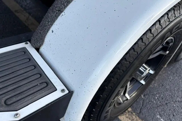 Slide: The Image of 2022 Vexus AVX2080 trailer wheel and fender detail, showcasing tire tread and step pad. - 49