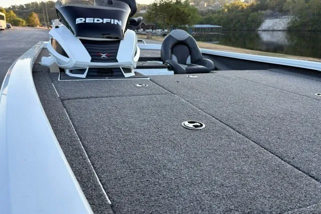 Slide: The Image of 2022 Vexus AVX2080 boat with spacious deck and seating, parked near a serene lake. - 25