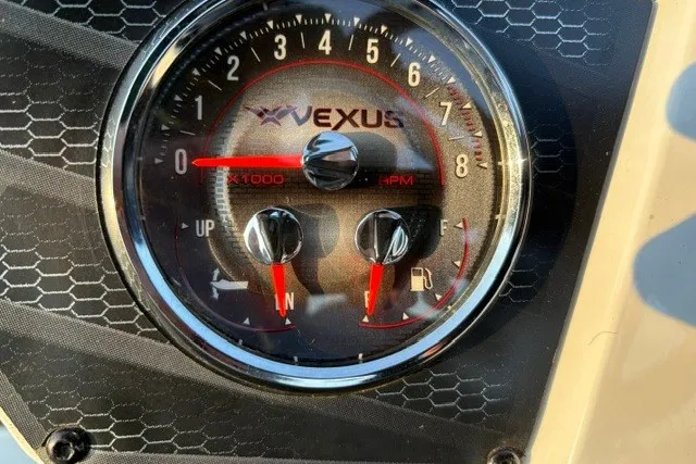 Slide: The Image of Close-up of 2022 Vexus AVX2080 dashboard gauge with hexagonal pattern background. - 31