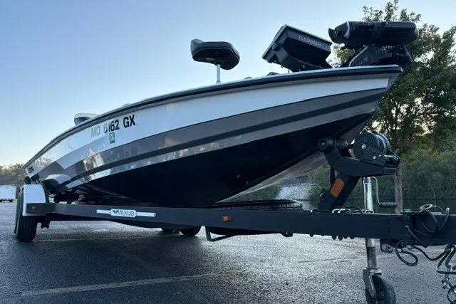 Slide: The Image of 2022 Vexus AVX2080 boat on trailer, parked outdoors, showcasing sleek design and modern features. - 24