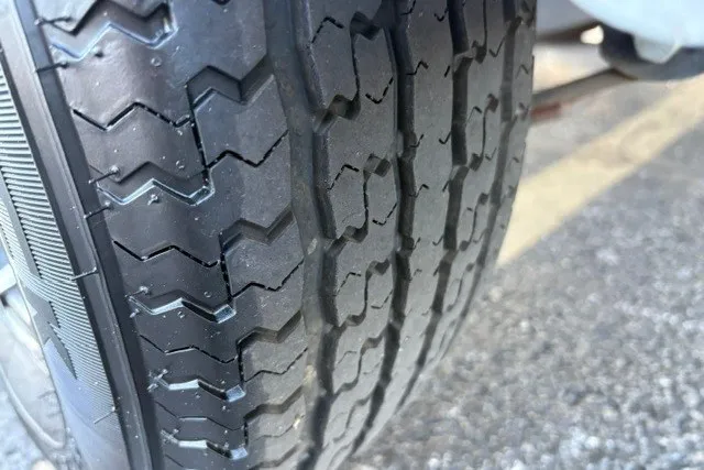 Slide: The Image of Close-up of a 2022 Vexus AVX2080 tire tread on pavement. - 66