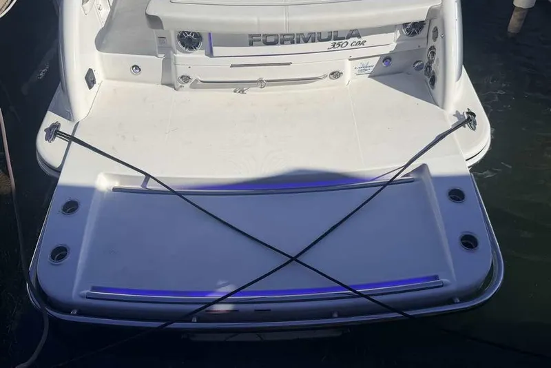 Slide: The Image of 2023 Formula 350 Crossover Bowrider I/O boat stern view at dock. - 4