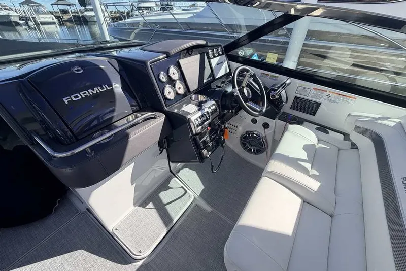 Slide: The Image of 2023 Formula 350 Crossover Bowrider I/O cockpit with modern controls and seating. - 12