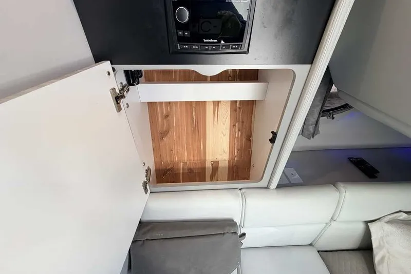 Slide: The Image of 2023 Formula 350 Crossover Bowrider I/O interior storage compartment with wooden finish. - 70