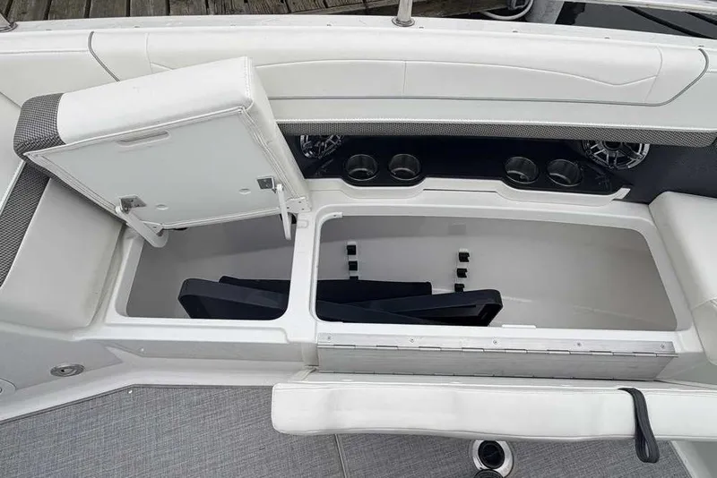 Slide: The Image of 2023 Formula 350 Crossover Bowrider I/O interior storage compartment with cup holders and seating. - 54