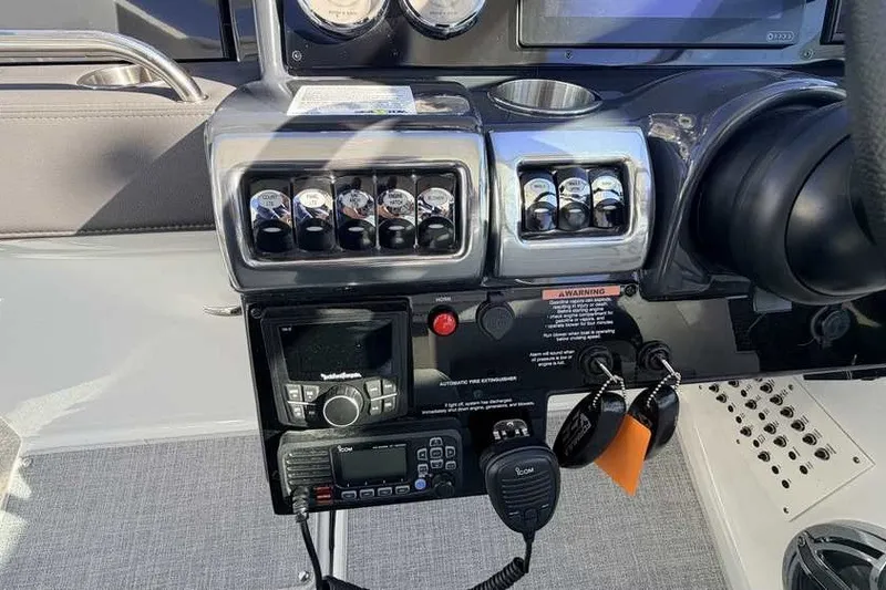 Slide: The Image of Control panel of 2023 Formula 350 Crossover Bowrider I/O with switches and communication devices. - 46