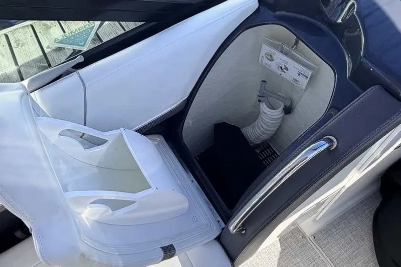 Slide: The Image of 2023 Formula 350 Crossover Bowrider I/O interior storage compartment with white seating. - 52