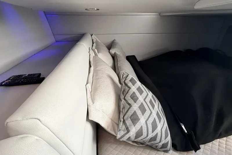 Slide: The Image of Interior cabin of 2023 Formula 350 Crossover Bowrider I/O with pillows and remote control. - 72