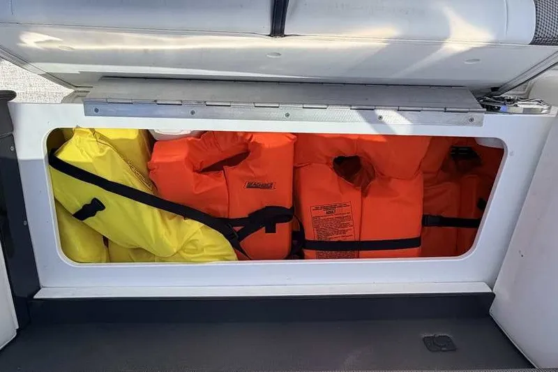Slide: The Image of Storage compartment with life jackets on a 2023 Formula 350 Crossover Bowrider I/O boat. - 51