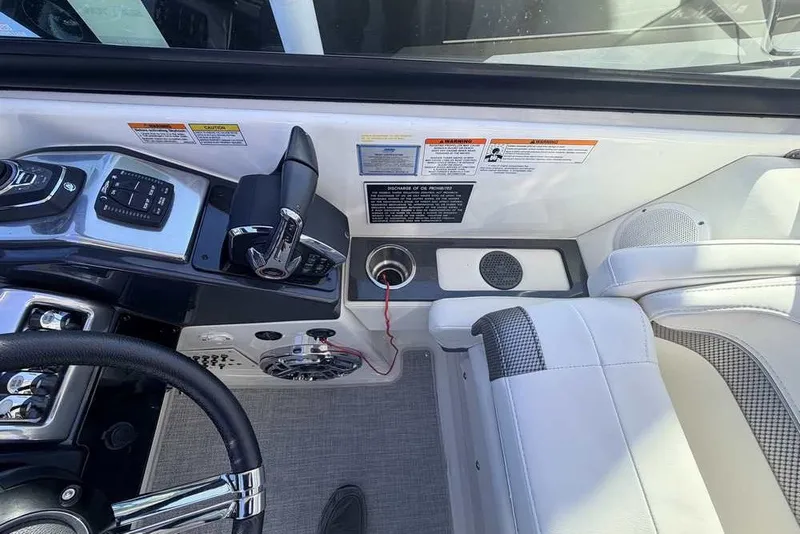 Slide: The Image of 2023 Formula 350 Crossover Bowrider I/O cockpit with steering wheel and control panel. - 25