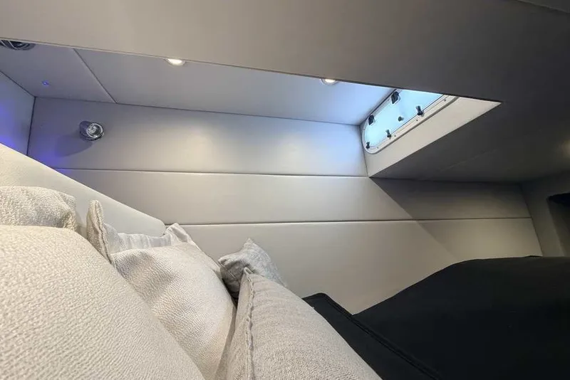 Slide: The Image of Interior cabin of 2023 Formula 350 Crossover Bowrider I/O with cushions and window. - 58