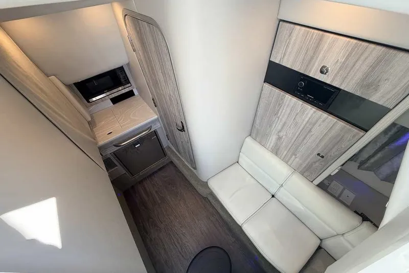 Slide: The Image of 2023 Formula 350 Crossover Bowrider I/O interior with modern seating and compact kitchenette. - 61
