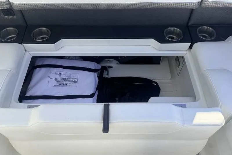 Slide: The Image of Storage compartment in 2023 Formula 350 Crossover Bowrider I/O with cup holders and safety gear. - 37