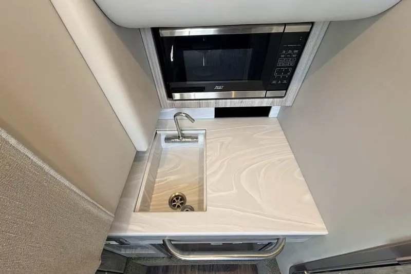 Slide: The Image of Compact kitchenette in 2023 Formula 350 Crossover Bowrider I/O with sink and microwave. - 68
