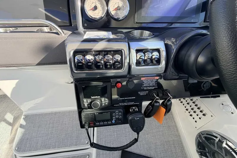 Slide: The Image of Control panel of 2023 Formula 350 Crossover Bowrider I/O with gauges and switches. - 24