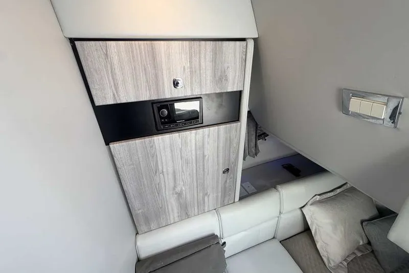 Slide: The Image of Interior of 2023 Formula 350 Crossover Bowrider I/O, featuring modern wood paneling and seating. - 69