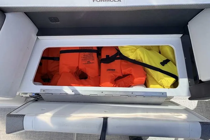 Slide: The Image of Storage compartment with life jackets on a 2023 Formula 350 Crossover Bowrider I/O boat. - 29