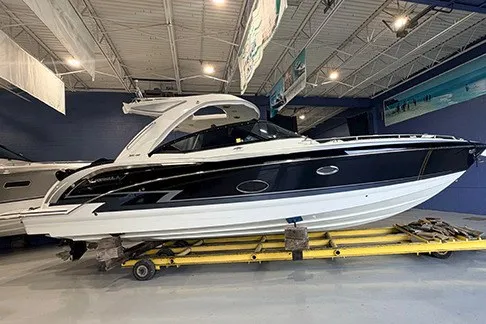 The Image of 2023 Formula 350 Crossover Bowrider I/O in showroom, sleek black and white design. - 0