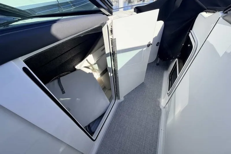 Slide: The Image of 2023 Formula 350 Crossover Bowrider I/O interior storage compartment with open door. - 14
