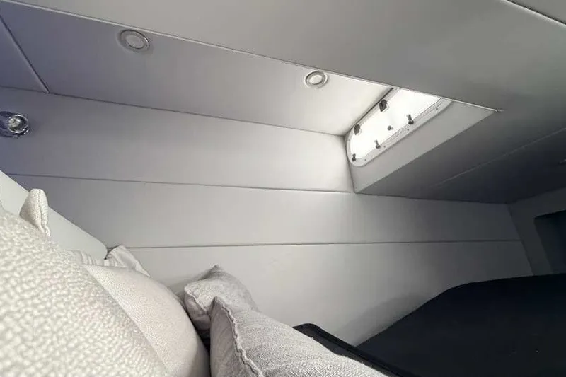 Slide: The Image of Interior cabin of 2023 Formula 350 Crossover Bowrider I/O with cushions and porthole. - 74