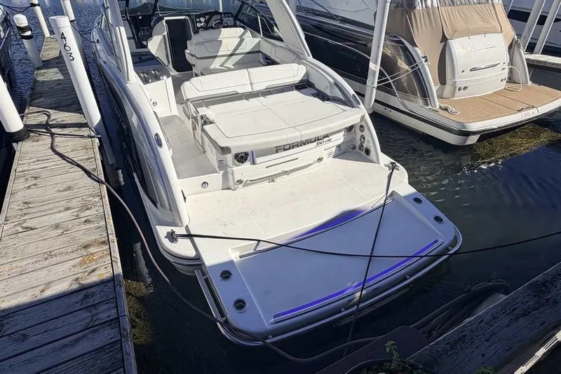 Slide: The Image of 2023 Formula 350 Crossover Bowrider I/O docked at marina, rear view. - 3