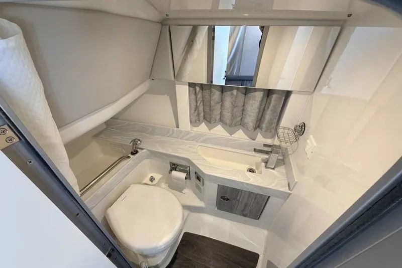 Slide: The Image of 2023 Formula 350 Crossover Bowrider I/O bathroom with modern fixtures and compact design. - 62