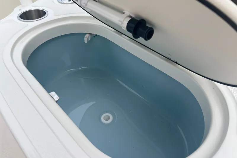 Slide: The Image of 2027 Boston Whaler 150 Montauk livewell with open lid, showcasing interior design. - 8