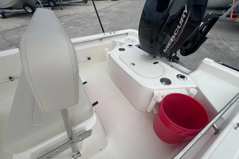 Slide: The Image of 2027 Boston Whaler 150 Montauk boat interior with Mercury engine and red bucket. - 7