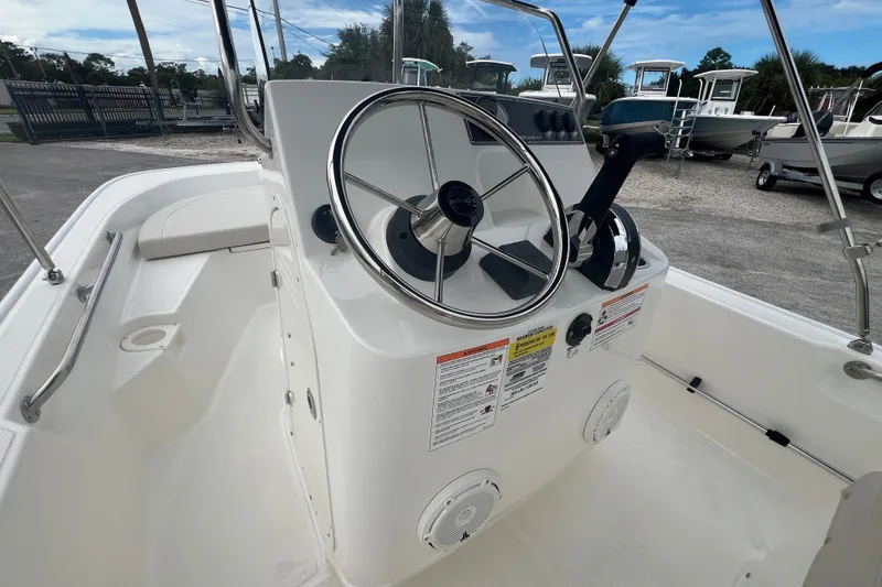 Slide: The Image of 2027 Boston Whaler 150 Montauk boat interior with steering wheel and control panel. - 9