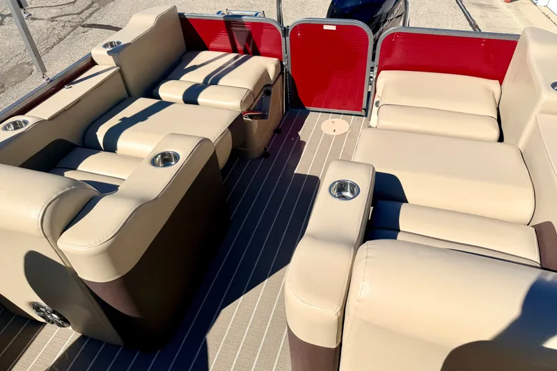 Slide: The Image of Luxurious seating on 2021 Manitou 23 Oasis pontoon boat with beige upholstery and cup holders. - 43