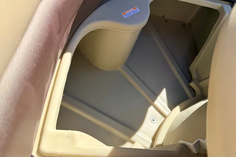 Slide: The Image of Storage compartment of 2021 Manitou 23 Oasis boat, featuring beige interior design. - 73