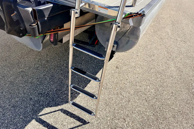 Slide: The Image of Stainless steel ladder on 2021 Manitou 23 Oasis pontoon boat, parked on asphalt. - 28