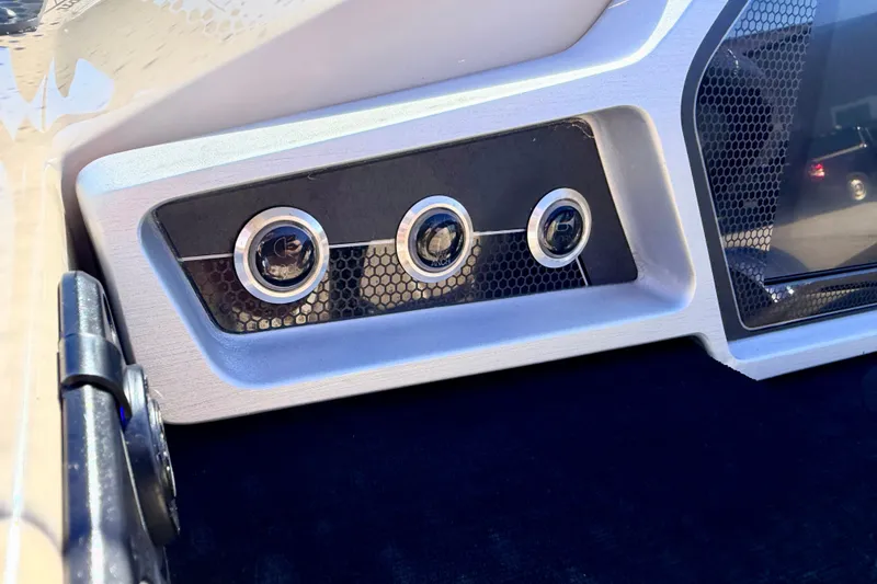 Slide: The Image of Dashboard controls of a 2021 Manitou 23 Oasis boat, featuring sleek design elements. - 47