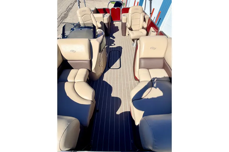 Slide: The Image of 2021 Manitou 23 Oasis pontoon boat interior with beige seating and spacious layout. - 85
