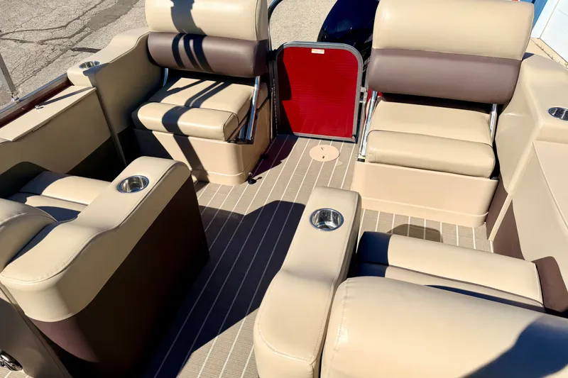 Slide: The Image of Interior seating of a 2021 Manitou 23 Oasis pontoon boat with beige and brown upholstery. - 42