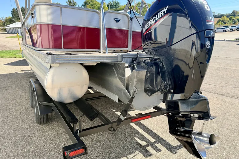 Slide: The Image of 2021 Manitou 23 Oasis pontoon boat with Mercury outboard motor on trailer. - 12